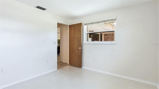 6529 Seagate Ave, Sarasota, FL 34231 - spare room with baseboards and speckle patterned floor