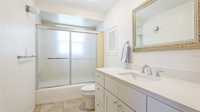 6529 Seagate Ave, Sarasota, FL 34231 - bathroom featuring toilet, vanity, shower / bath combination with glass door, and tile patterned floors