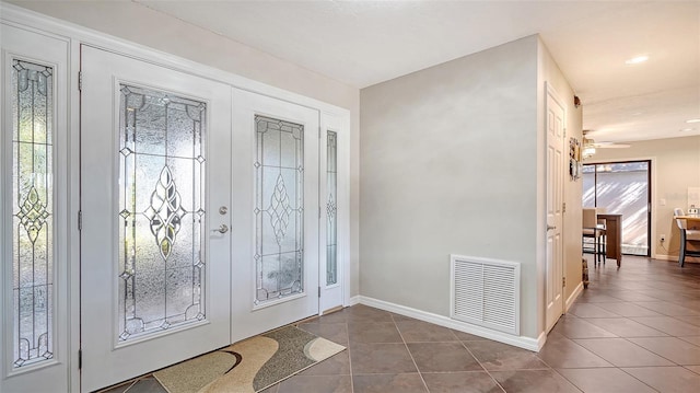 3761 Countryside Rd, Sarasota, FL 34233 - entrance foyer with dark tile patterned flooring, baseboards, ceiling fan, and visible vents