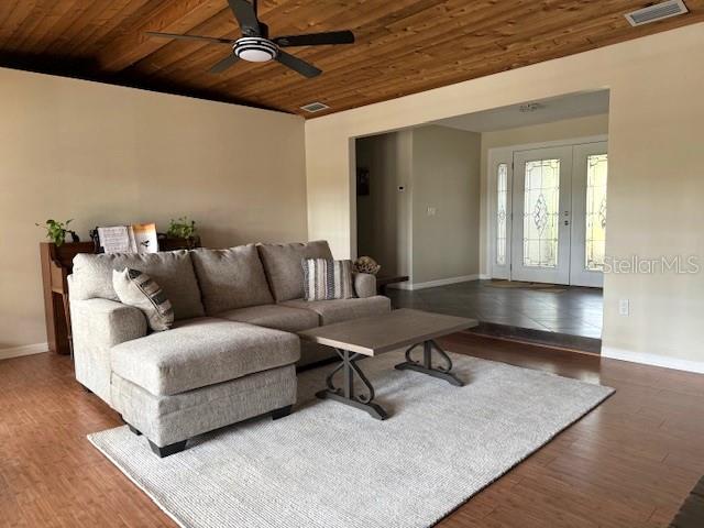 3761 Countryside Rd, Sarasota, FL 34233 - living room featuring wood ceiling, a ceiling fan, visible vents, wood finished floors, and baseboards
