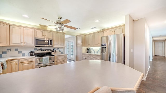 3761 Countryside Rd, Sarasota, FL 34233 - kitchen with ceiling fan, appliances with stainless steel finishes, visible vents, and tasteful backsplash