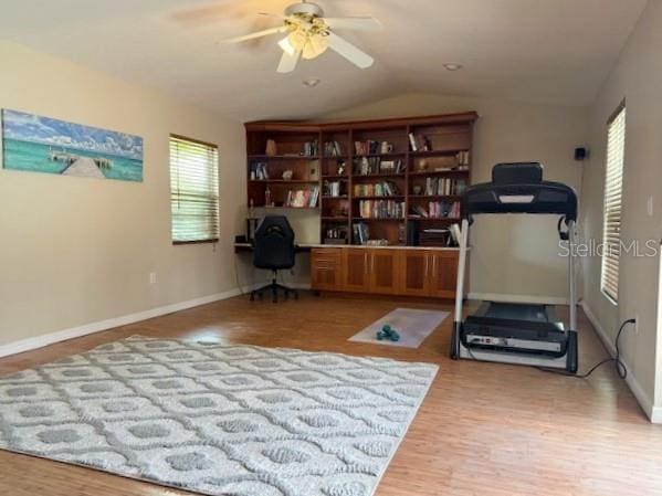 3761 Countryside Rd, Sarasota, FL 34233 - workout room with baseboards, a ceiling fan, wood finished floors, and lofted ceiling