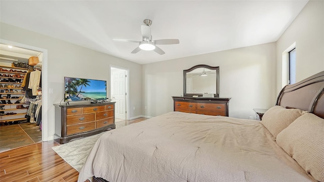 3761 Countryside Rd, Sarasota, FL 34233 - bedroom with a ceiling fan, baseboards, wood finished floors, a spacious closet, and a closet