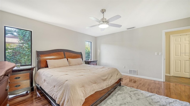 3761 Countryside Rd, Sarasota, FL 34233 - bedroom featuring baseboards, a ceiling fan, wood finished floors, and visible vents