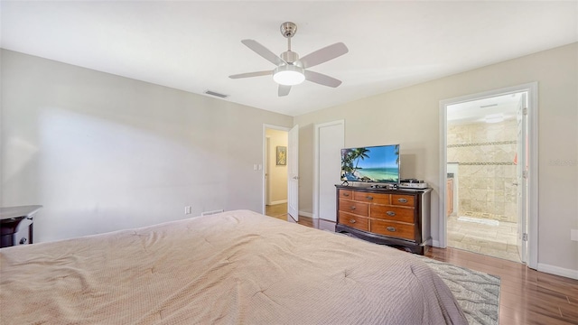 3761 Countryside Rd, Sarasota, FL 34233 - bedroom featuring connected bathroom, a ceiling fan, baseboards, wood finished floors, and visible vents