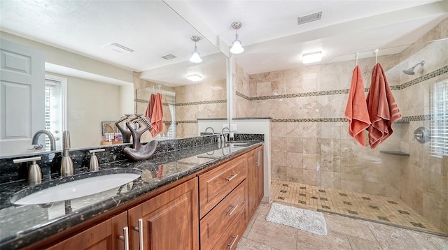 3761 Countryside Rd, Sarasota, FL 34233 - bathroom with visible vents, a sink, and tiled shower