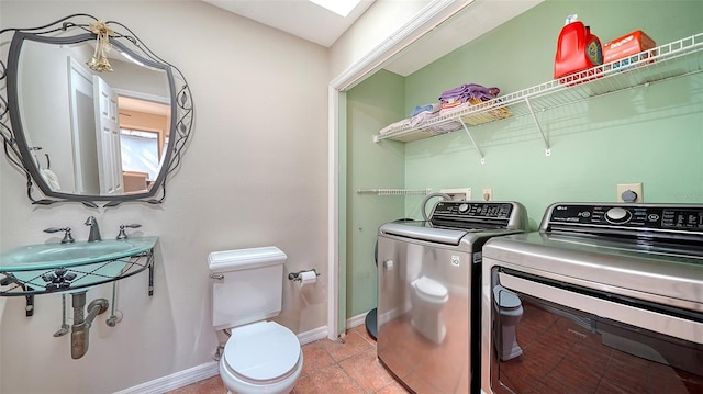 3761 Countryside Rd, Sarasota, FL 34233 - laundry area with baseboards, washer and clothes dryer, light tile patterned floors, and laundry area