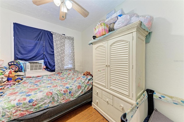 432 Adelia Ave, Sarasota, FL 34236 - bedroom featuring a ceiling fan, light wood finished floors, a textured ceiling, and cooling unit