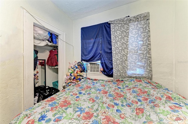 432 Adelia Ave, Sarasota, FL 34236 - bedroom with a textured ceiling, a textured wall, a closet, and cooling unit