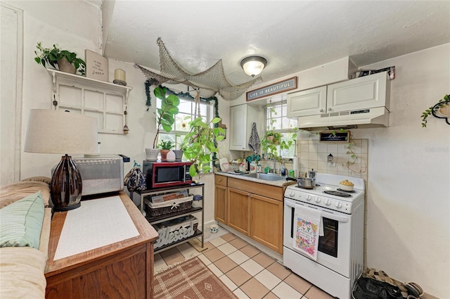 432 Adelia Ave, Sarasota, FL 34236 - kitchen featuring white electric range, a sink, under cabinet range hood, and light countertops