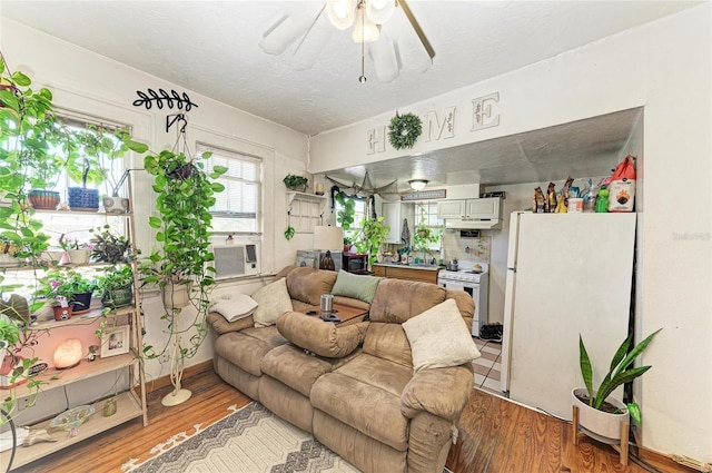 432 Adelia Ave, Sarasota, FL 34236 - living area with light wood-style floors, cooling unit, and a ceiling fan