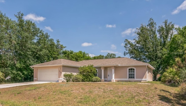 ranch-style home featuring concrete driveway, an attached garage, a front yard, and stucco siding
