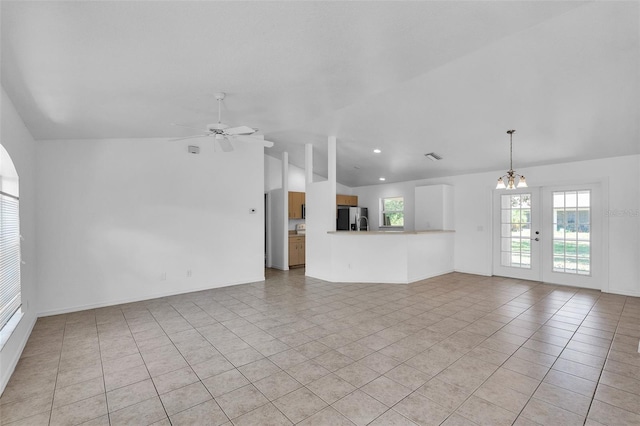 unfurnished living room featuring recessed lighting, light tile patterned floors, lofted ceiling, and ceiling fan with notable chandelier