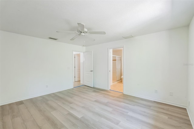 unfurnished bedroom with light wood-style floors, baseboards, and visible vents
