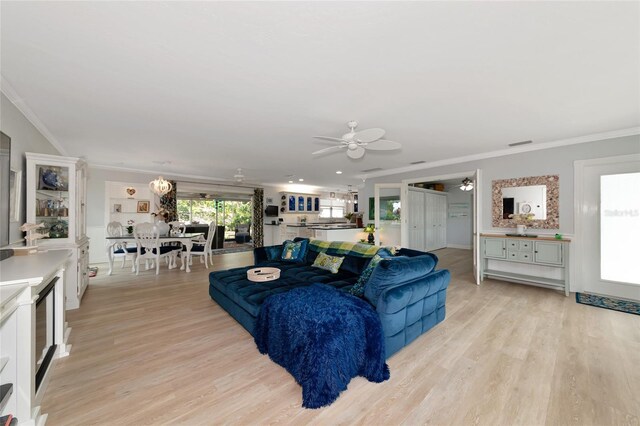 1722 Hazelwood St, Sarasota, FL 34231 - living area with ceiling fan, light wood-style flooring, ornamental molding, and baseboards