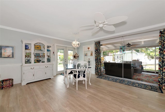 1722 Hazelwood St, Sarasota, FL 34231 - dining room featuring ceiling fan, french doors, healthy amount of natural light, ornamental molding, and a wainscoted wall