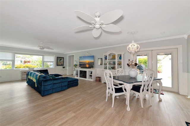 1722 Hazelwood St, Sarasota, FL 34231 - dining space featuring a ceiling fan, light wood-style floors, ornamental molding, and a chandelier