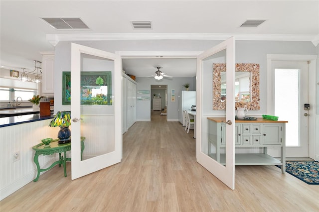 1722 Hazelwood St, Sarasota, FL 34231 - foyer with light wood finished floors, crown molding, french doors, ceiling fan, and baseboards