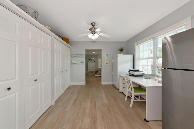 1722 Hazelwood St, Sarasota, FL 34231 - kitchen with freestanding refrigerator, light wood-style floors, ceiling fan, light countertops, and a desk