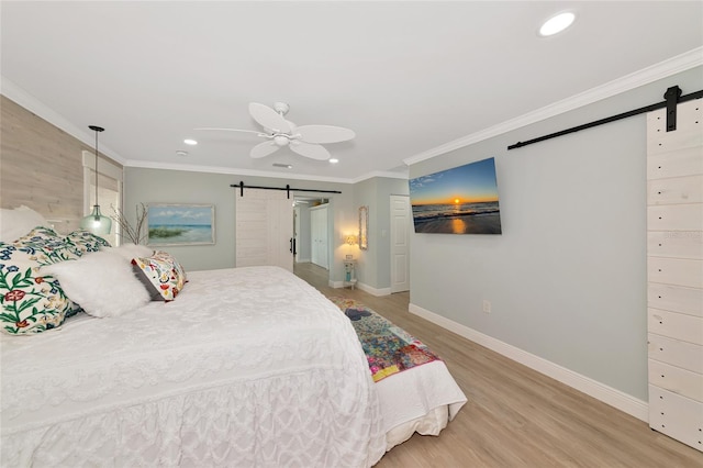 1722 Hazelwood St, Sarasota, FL 34231 - bedroom featuring a barn door, recessed lighting, baseboards, ornamental molding, and wood finished floors