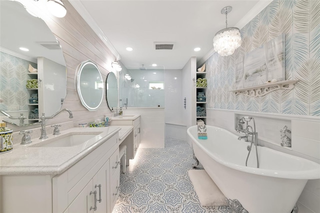 1722 Hazelwood St, Sarasota, FL 34231 - bathroom with wallpapered walls, a freestanding bath, ornamental molding, a walk in shower, and two vanities