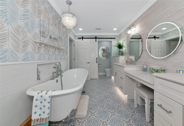 1722 Hazelwood St, Sarasota, FL 34231 - bathroom featuring ornamental molding, vanity, a freestanding tub, toilet, and tile patterned flooring