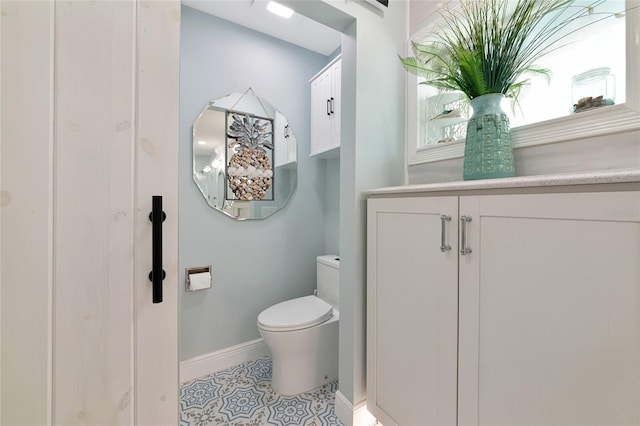 1722 Hazelwood St, Sarasota, FL 34231 - bathroom with baseboards, toilet, and tile patterned flooring