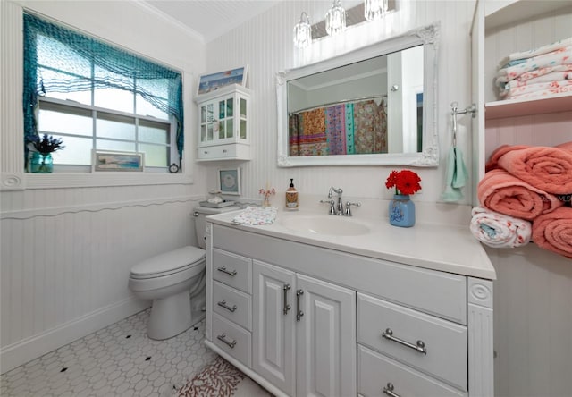 1722 Hazelwood St, Sarasota, FL 34231 - bathroom featuring toilet, vanity, ornamental molding, baseboards, and tile patterned floors