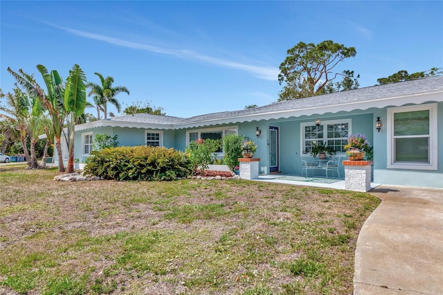 1722 Hazelwood St, Sarasota, FL 34231 - ranch-style home featuring stucco siding and a front yard