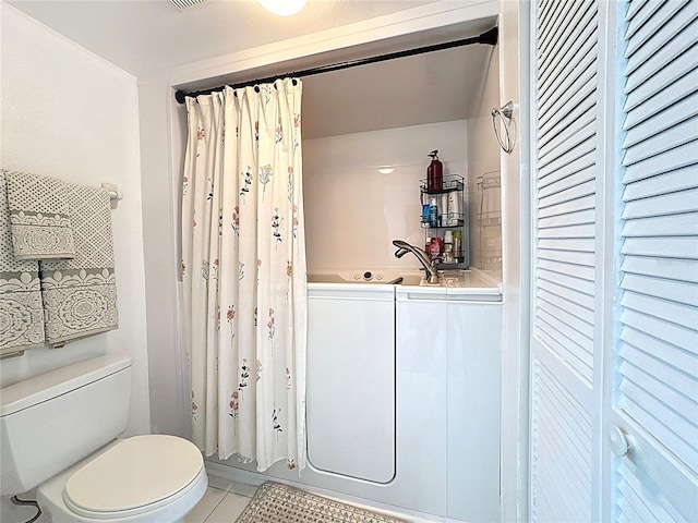 bathroom featuring tile patterned floors, toilet, and a shower with curtain