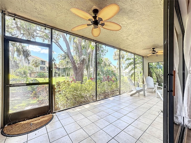 unfurnished sunroom with plenty of natural light and ceiling fan