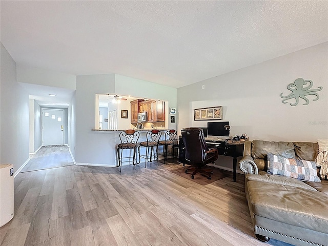 office featuring baseboards and light wood-style floors