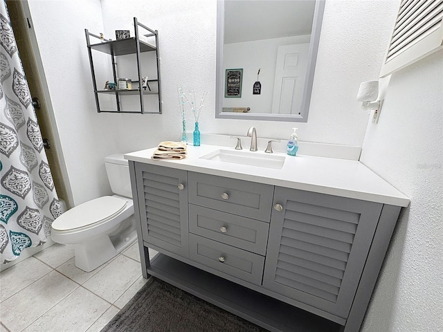 full bathroom with vanity, toilet, and tile patterned flooring
