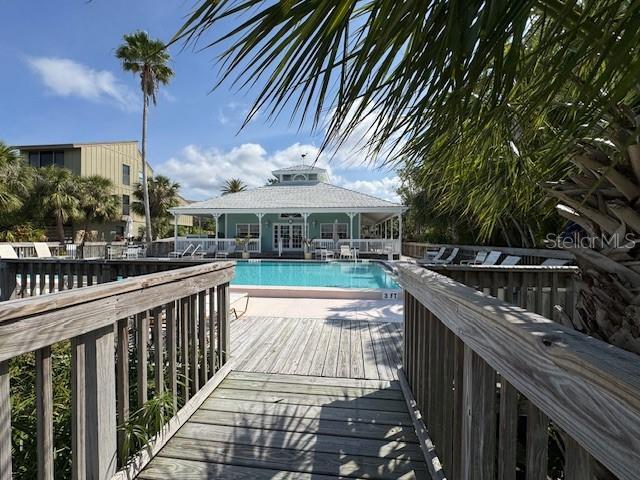 pool with a patio area and a deck