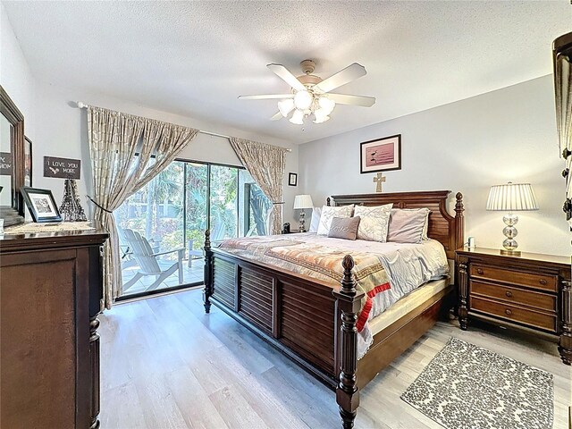 5234 Lake Arrowhead Trl Unit 30, Sarasota, FL 34231 - bedroom featuring access to outside, light wood-type flooring, a textured ceiling, and a ceiling fan
