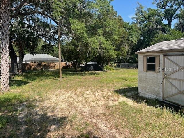 6383 N Jade Ter, Crystal River, FL 34428 - view of yard with a storage unit, fence, and an outbuilding