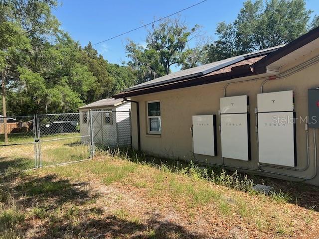 6383 N Jade Ter, Crystal River, FL 34428 - view of property exterior featuring fence, a gate, and stucco siding