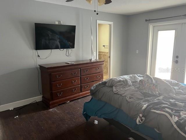 6383 N Jade Ter, Crystal River, FL 34428 - bedroom with ceiling fan, baseboards, ensuite bathroom, and wood finished floors