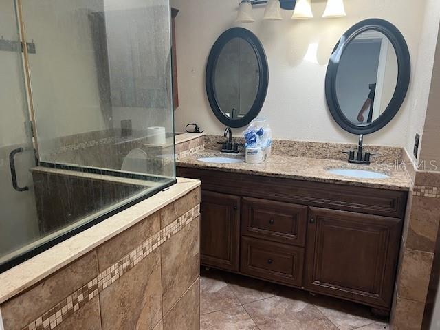 6383 N Jade Ter, Crystal River, FL 34428 - full bath with double vanity, a shower stall, and a sink