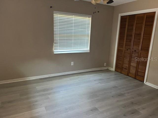 6383 N Jade Ter, Crystal River, FL 34428 - unfurnished bedroom featuring baseboards, ceiling fan, wood finished floors, and a closet