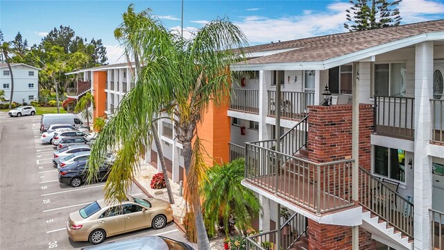2321 Canal Dr Unit F25, Bradenton, FL 34207 - view of property with stairway and uncovered parking