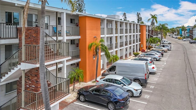 2321 Canal Dr Unit F25, Bradenton, FL 34207 - view of building exterior with stairs and uncovered parking
