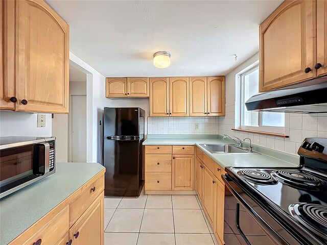 2321 Canal Dr Unit F25, Bradenton, FL 34207 - kitchen with black appliances, a sink, light brown cabinetry, and range hood