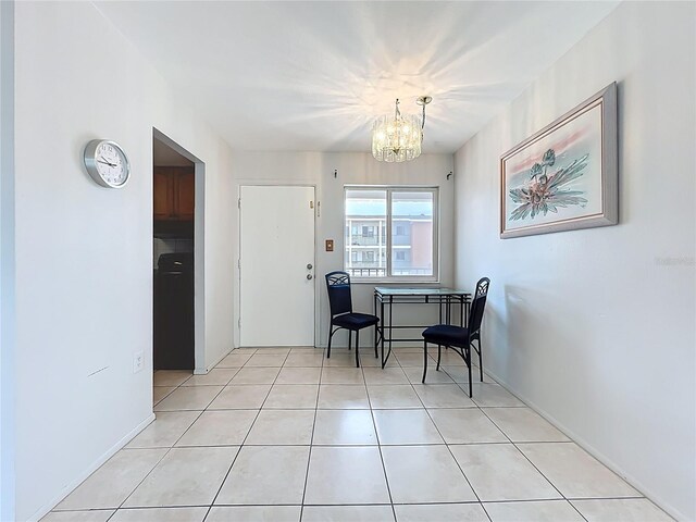 2321 Canal Dr Unit F25, Bradenton, FL 34207 - entrance foyer with a chandelier and light tile patterned floors