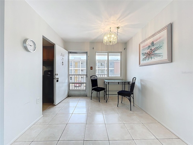 2321 Canal Dr Unit F25, Bradenton, FL 34207 - dining area with a chandelier, light tile patterned floors, and baseboards