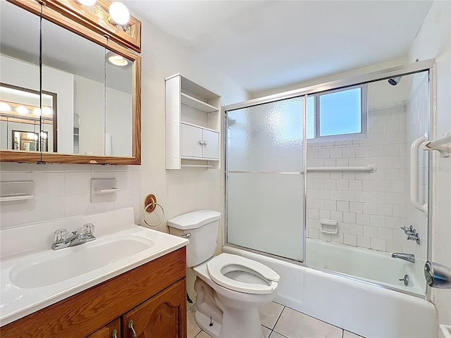 2321 Canal Dr Unit F25, Bradenton, FL 34207 - full bath featuring toilet, vanity, bath / shower combo with glass door, and tile patterned floors