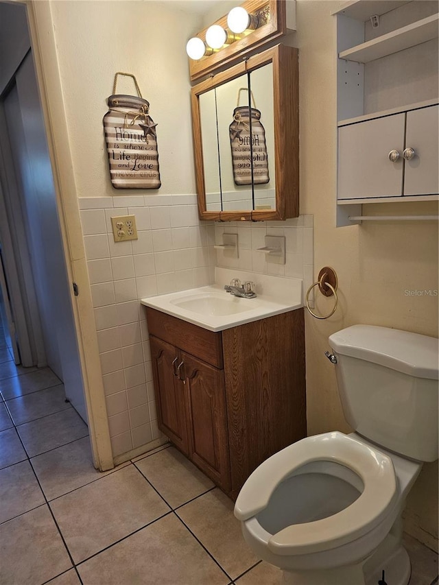 2321 Canal Dr Unit F25, Bradenton, FL 34207 - half bath with toilet, vanity, tile walls, tile patterned floors, and wainscoting