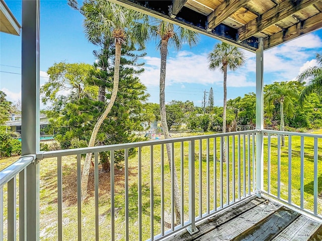 2321 Canal Dr Unit F25, Bradenton, FL 34207 - wooden terrace with view of wooded area and a lawn