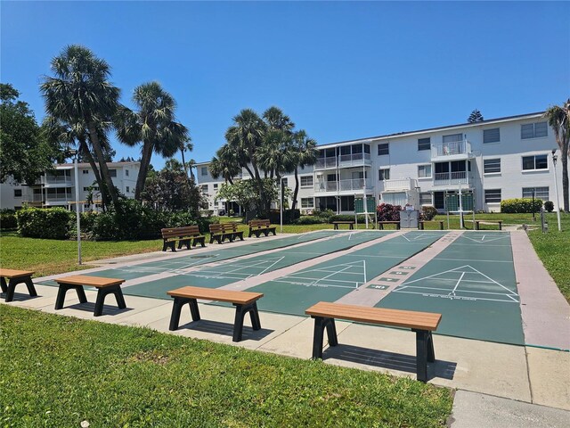 2321 Canal Dr Unit F25, Bradenton, FL 34207 - view of community featuring a yard and shuffleboard