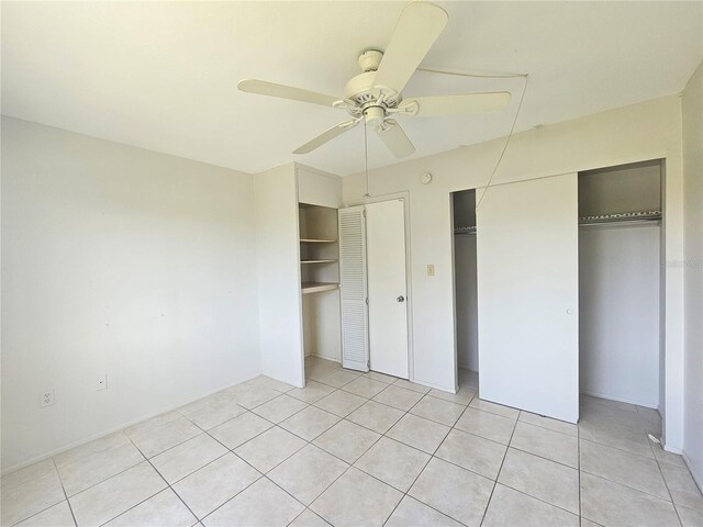 2321 Canal Dr Unit F25, Bradenton, FL 34207 - unfurnished bedroom featuring light tile patterned flooring, two closets, and ceiling fan